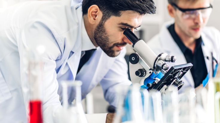 Man seeing in to the microscope